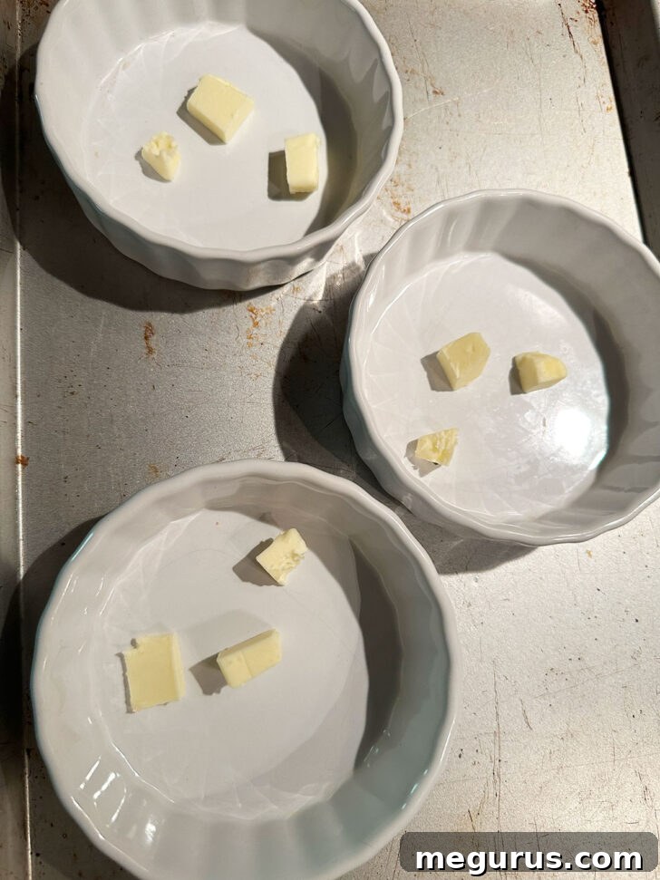Adding pieces of cold butter to ramekins.