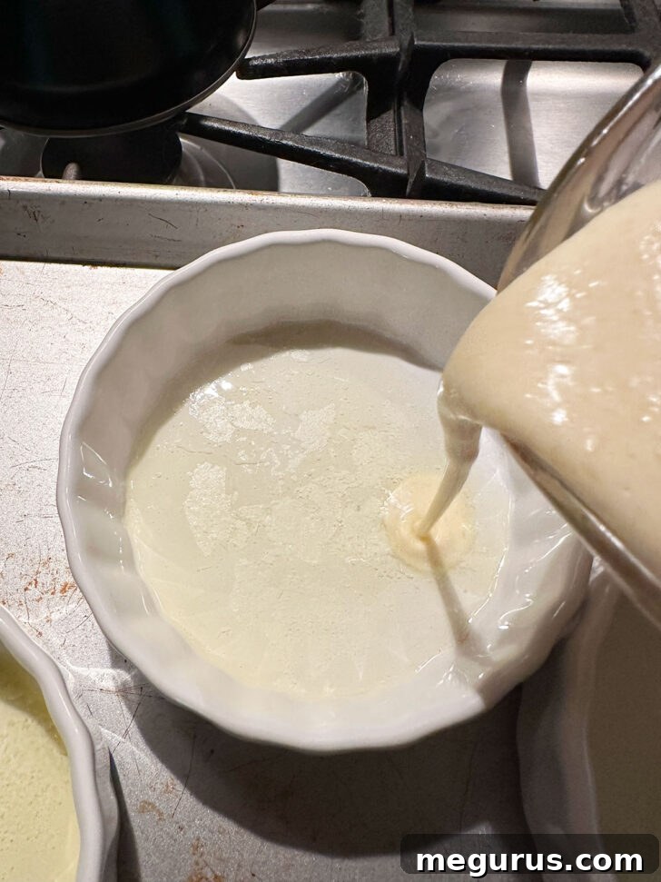Pouring batter into the ramekins.