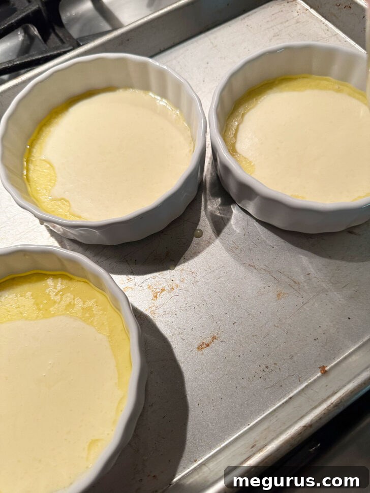 Ramekins on a baking sheet before baking.