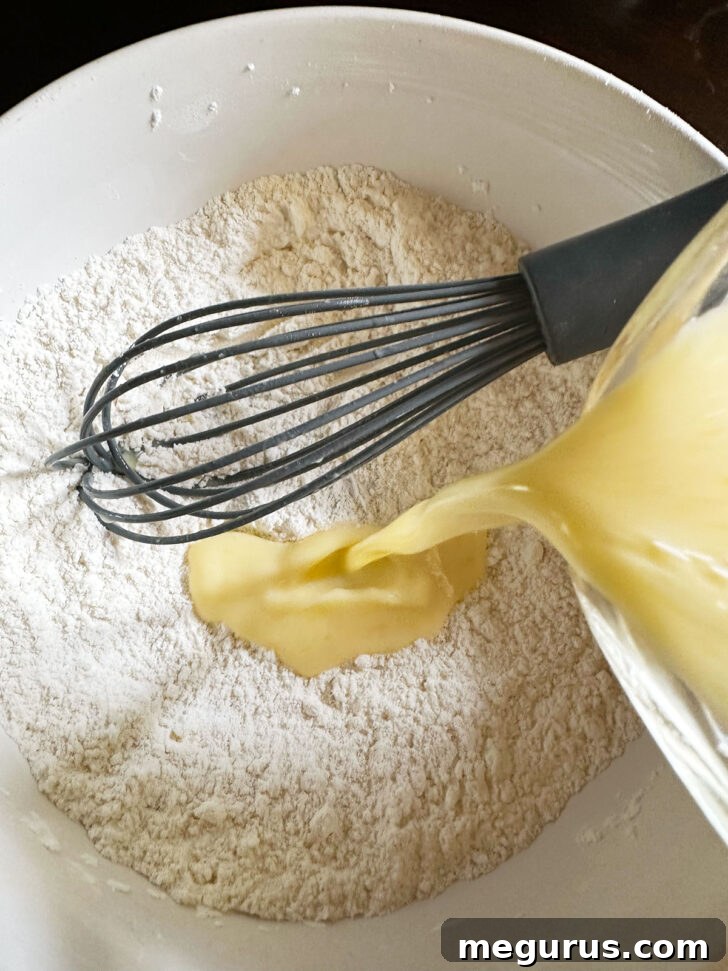 Adding some of the egg mixture to the dry ingredients.