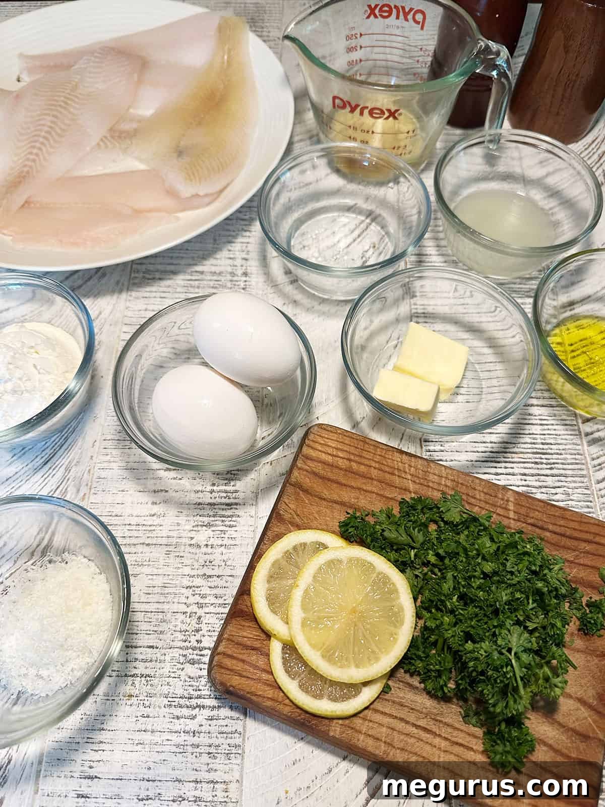 Ingredients for Sole Francese including sole fillets, lemons, eggs, parsley, butter, wine, and flour.