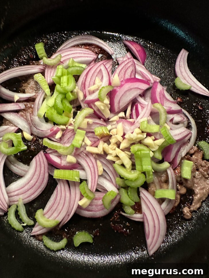 Onion, celery and garlic added to the skillet after removing the steaks.