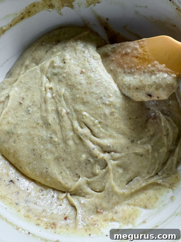 The pistachio mixture gently folded into the reserved batter, creating a marbled effect, ready to be layered.