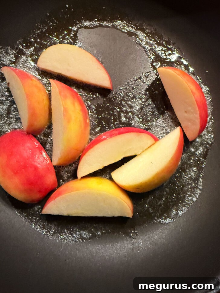 Browning apples in butter in a skillet.
