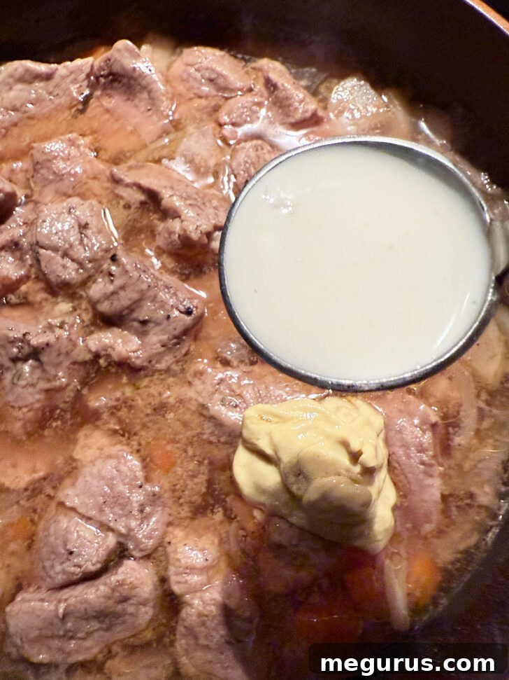 Adding mustard and cream to skillet after cooking.
