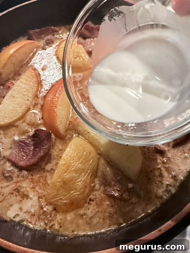 Thickening the gravy with a cornstarch slurry.