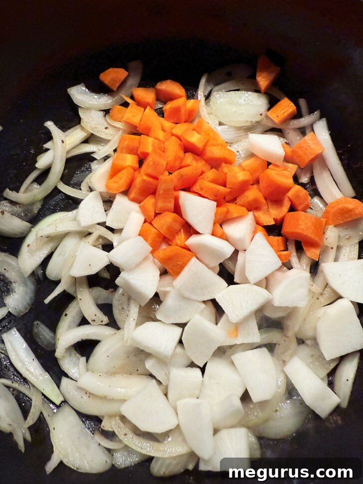 Adding carrots and parsnips to skillet.
