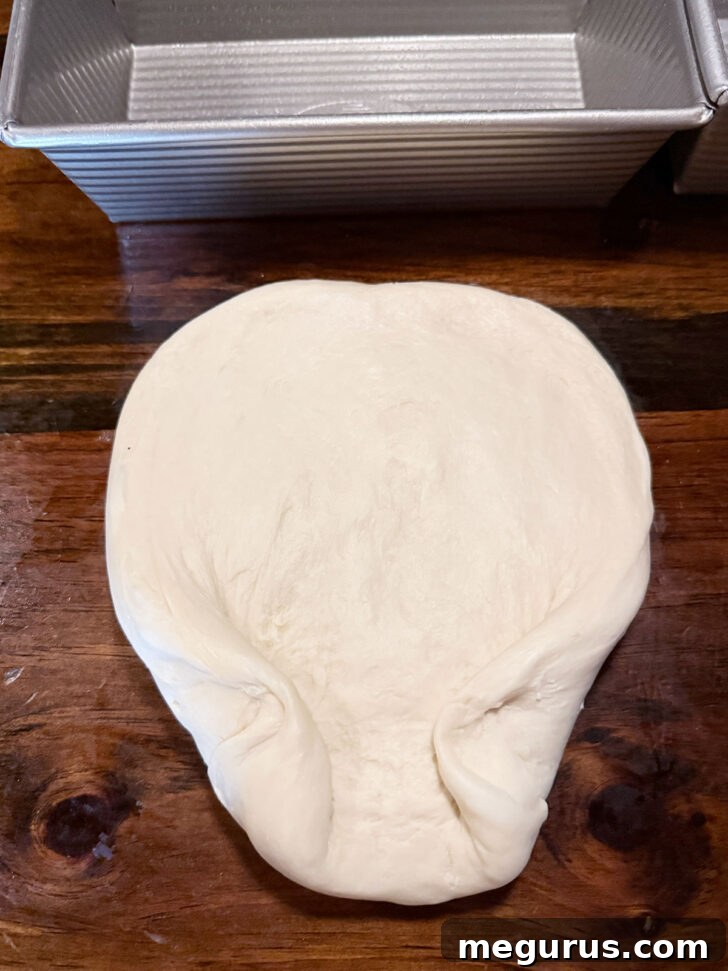 Folding dough prior to rolling up.
