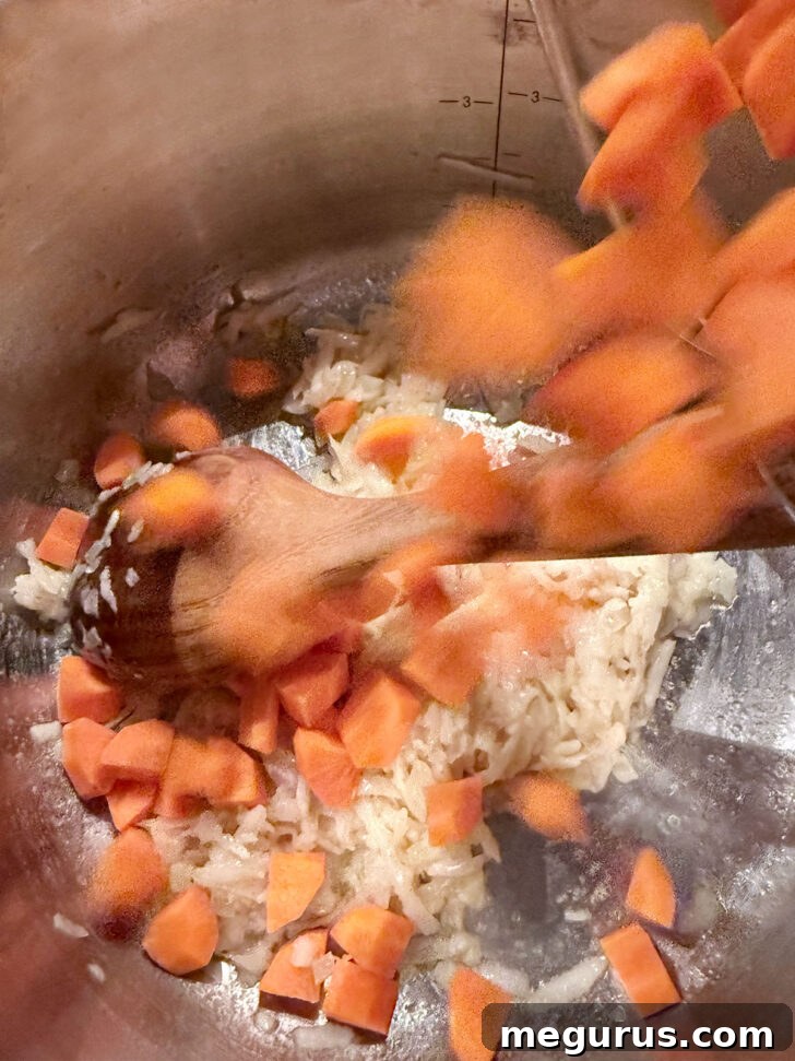Adding the carrots to the pot.