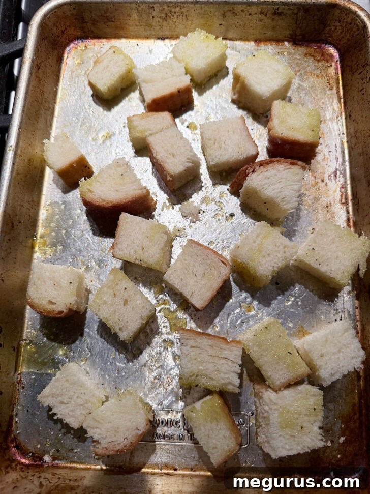Cubed bread on a baking sheet for the croutons.