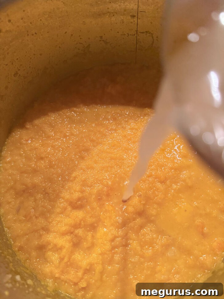 Thinning the soup with addition broth.