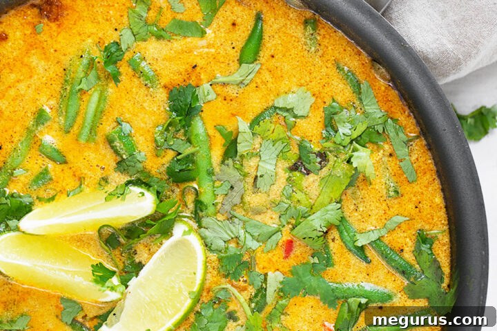 A vibrant and aromatic Chicken Peanut Butter Curry in a skillet, ready to be served.