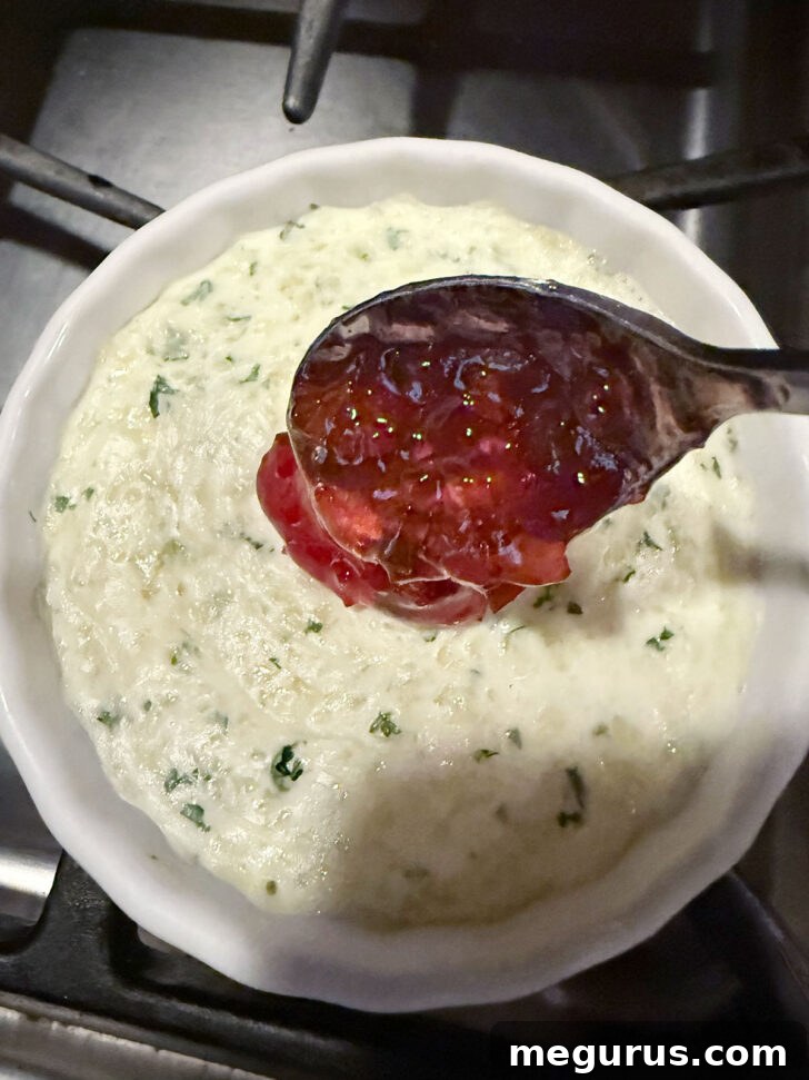 Topping dip with pepper jelly after baking.