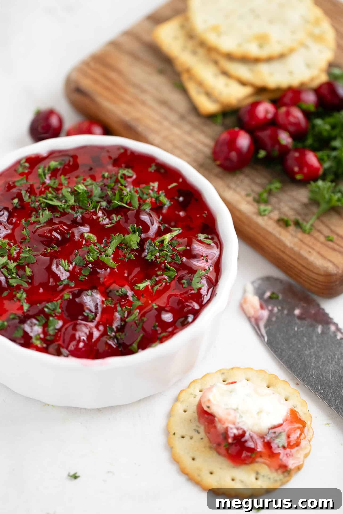 Pepper jelly topped cream cheese dip in ramekin.