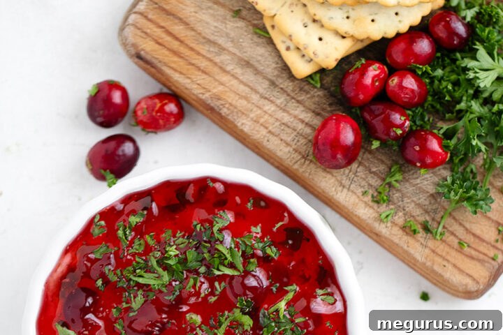 Pepper jelly topped cream cheese dip with crackers.