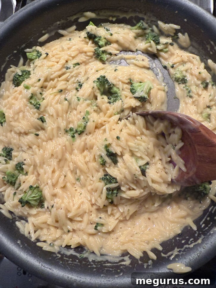 Finished broccoli cheddar orzo in the skillet.