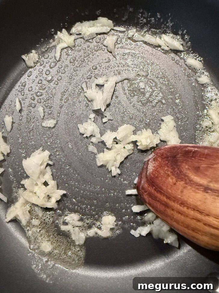 Cooking onion in melted butter in the skillet.