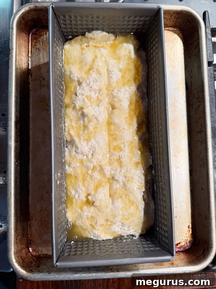 Loaf pan placed on a baking sheet, ready to go into the oven.