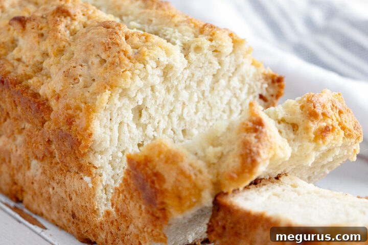 Honey beer bread sliced on cutting board.