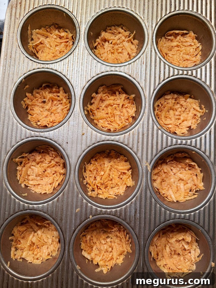 Shredded sweet potato pressed into muffin cups, forming the crust.