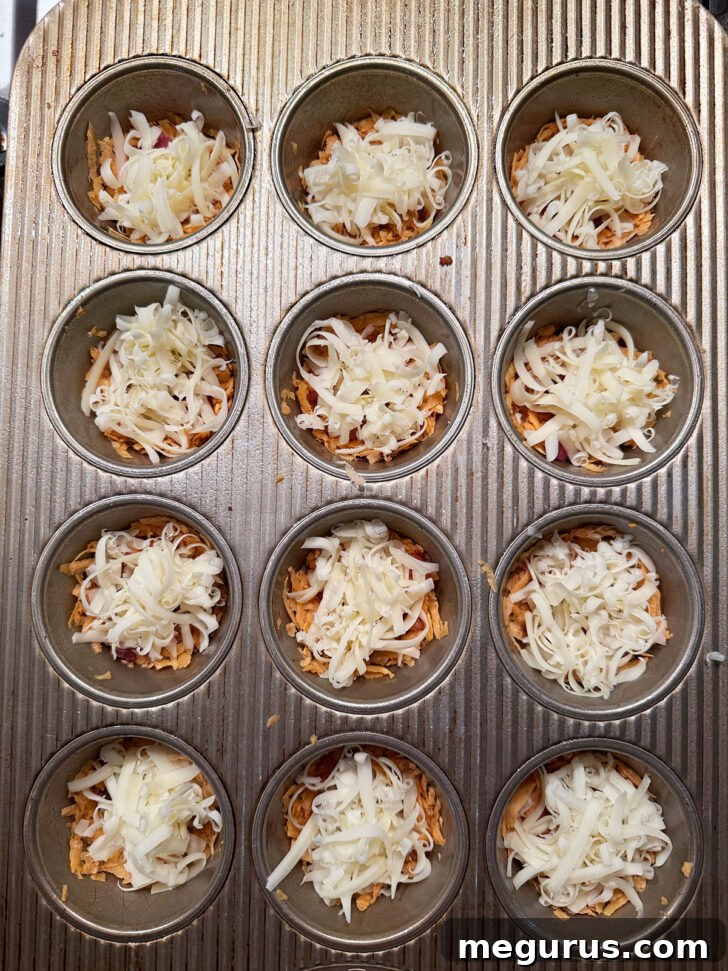Shredded cheese added to the muffin cups, mounded in the center.