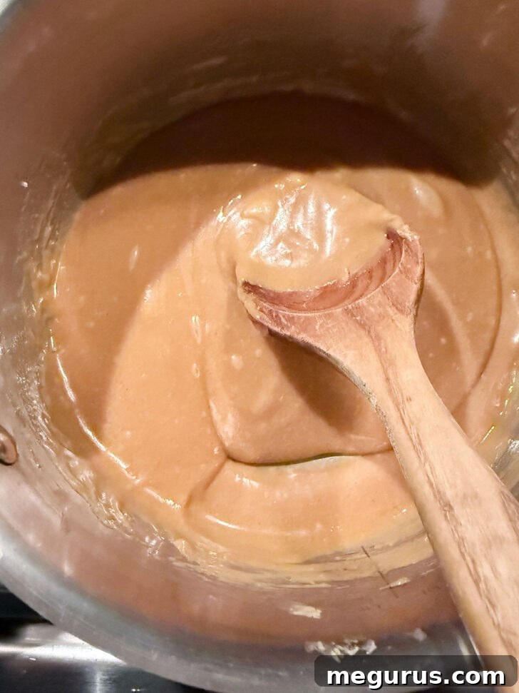 Peanut butter mixture in saucepan after heating.
