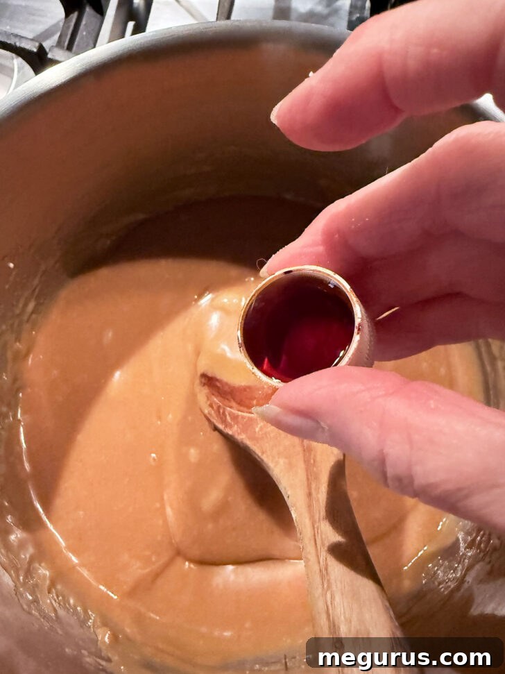 Adding vanilla to the peanut butter mixture.