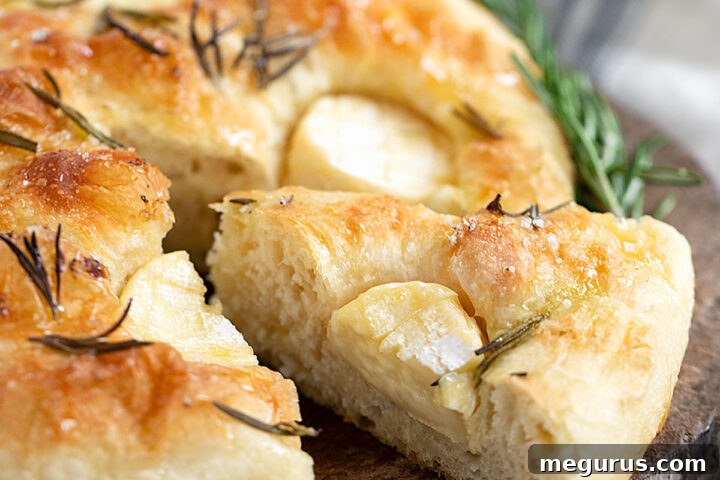 Mini Brie focaccia sliced on cutting board.