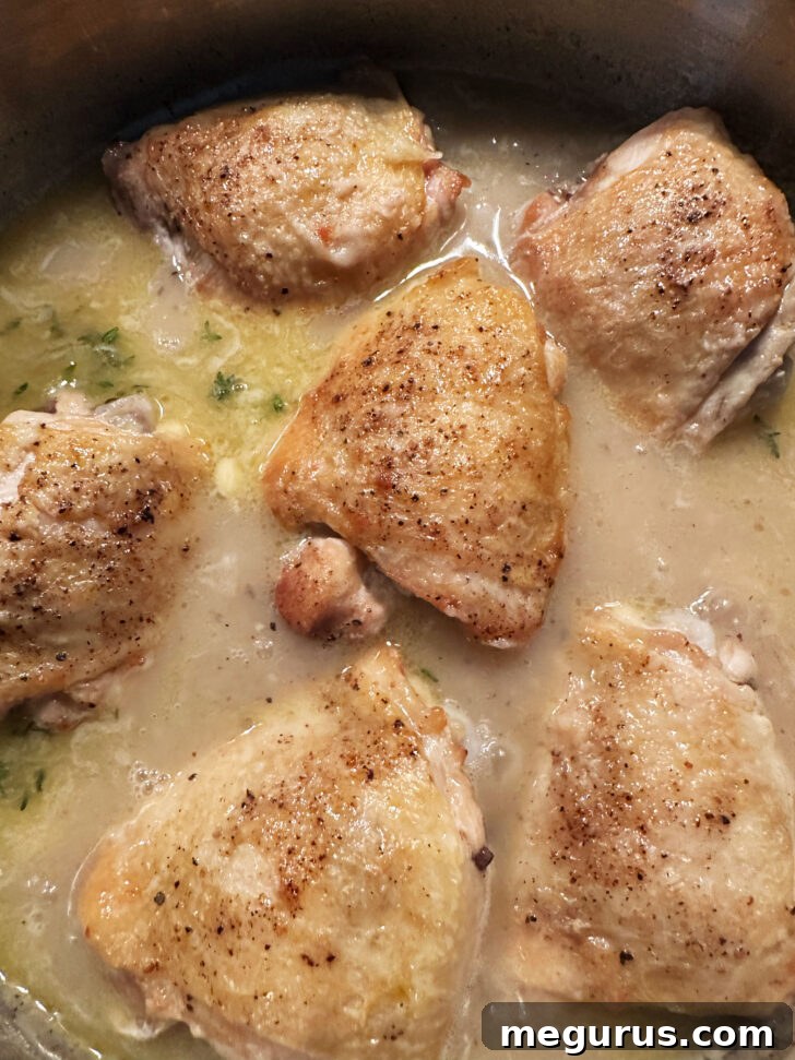 The chicken thighs returned to the pan, gently simmering in the rich, thick gravy.