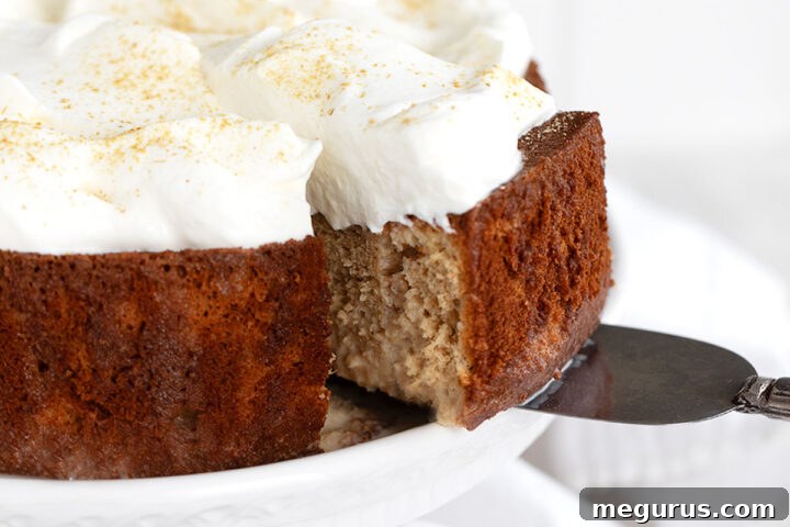 Gingerbread tres leches cake sliced on cake plate.