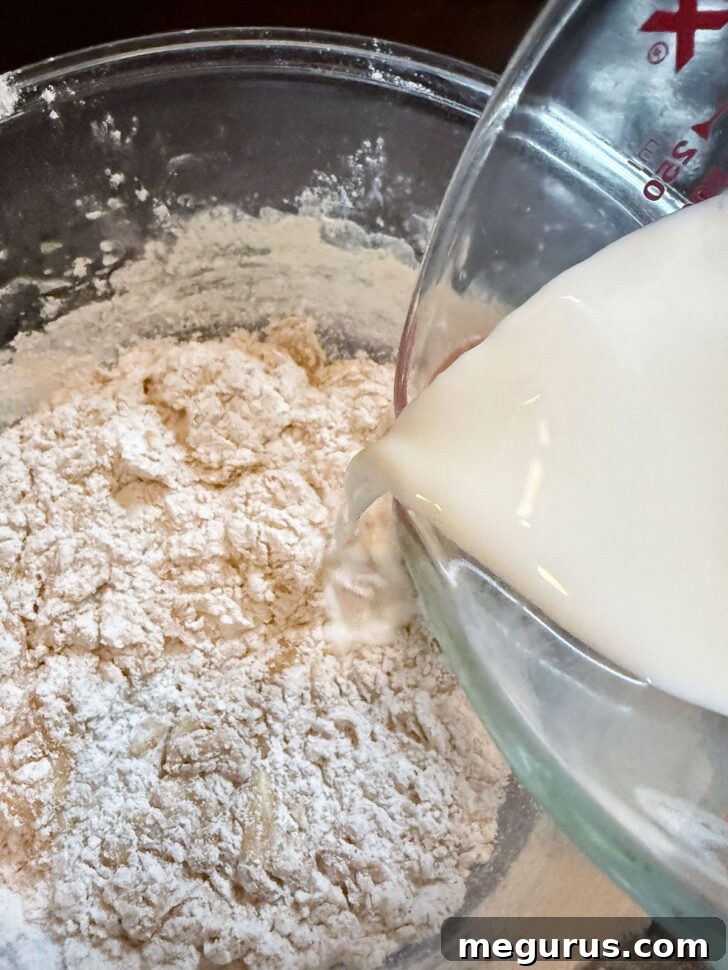 Adding flour, spices, and milk to the egg yolk batter mixture.