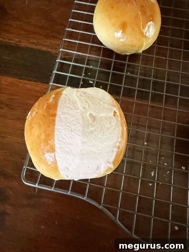 Maritozzi after scraping off the excess whipped cream, revealing a neat, generous filling.
