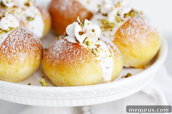 Pistachio maritozzi on a cake plate.