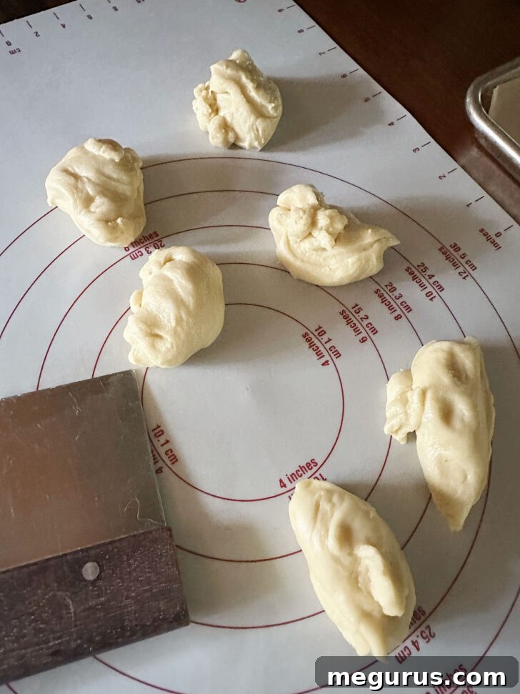 Portioned dough balls arranged on a work surface, ready for shaping.