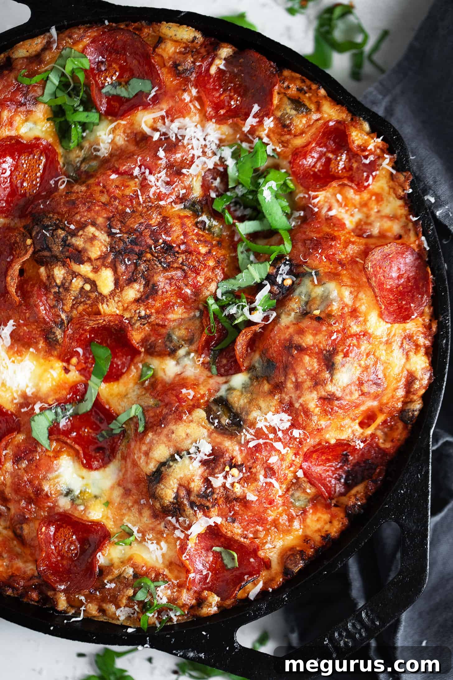 Close-up of a slice of focaccia pizza with pepperoni and melted cheese, showing the airy crust texture.