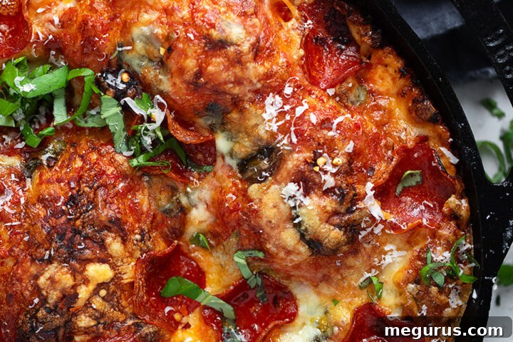 Focaccia pizza with pepperoni in a cast iron skillet.