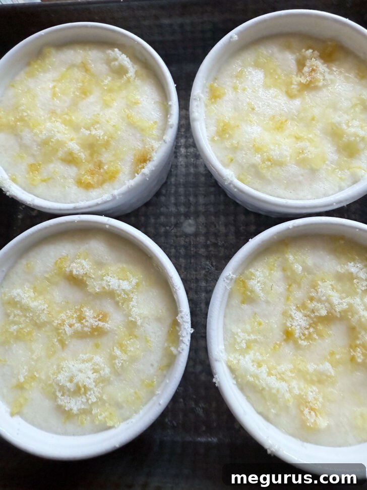 Ramekins filled with batter and topped with lemon sugar before baking in a water bath.