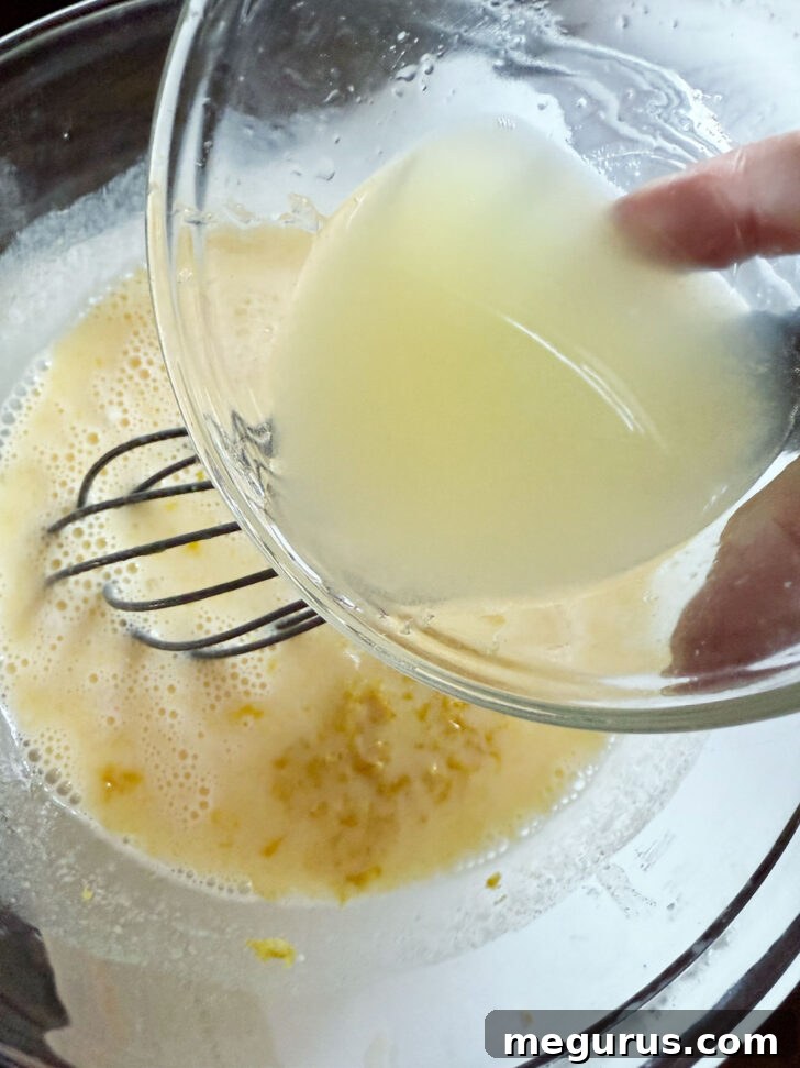 Adding fresh lemon juice and lemon zest to the batter.