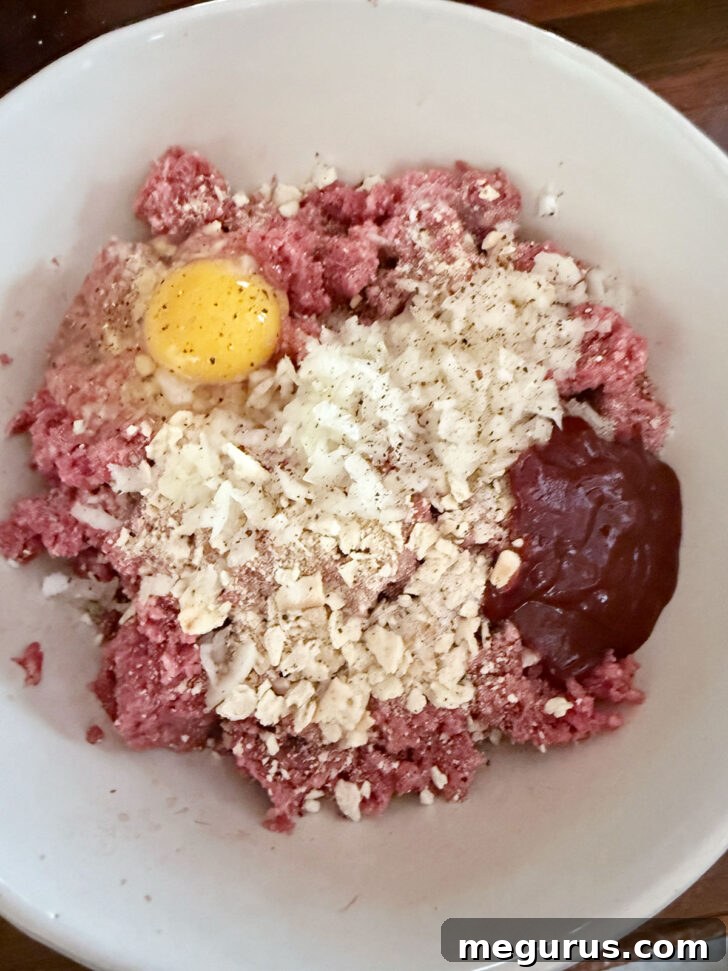 Meatloaf ingredients waiting to be combined in a large mixing bowl.