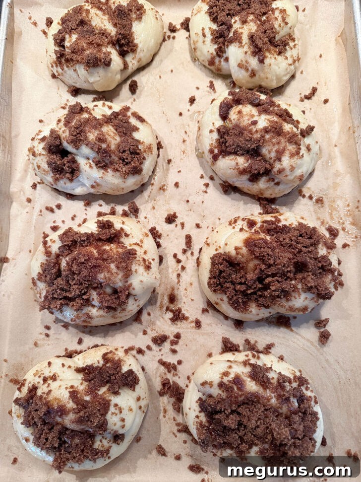Cinnamon crunch topping pressed onto pretzels before baking.