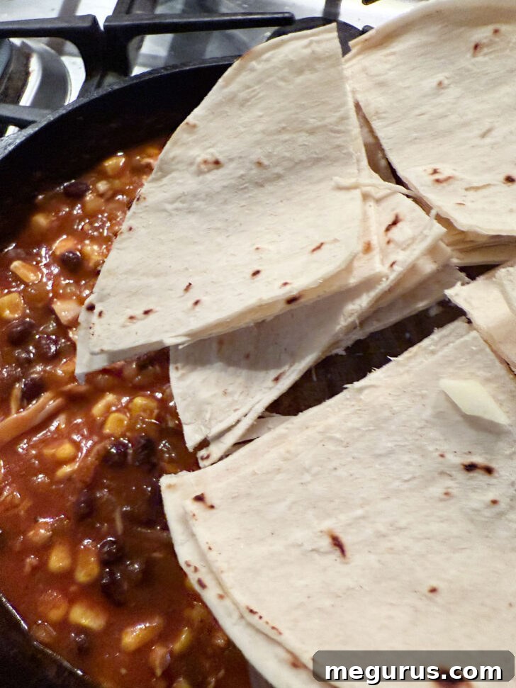 Adding the cut tortillas to the skillet.