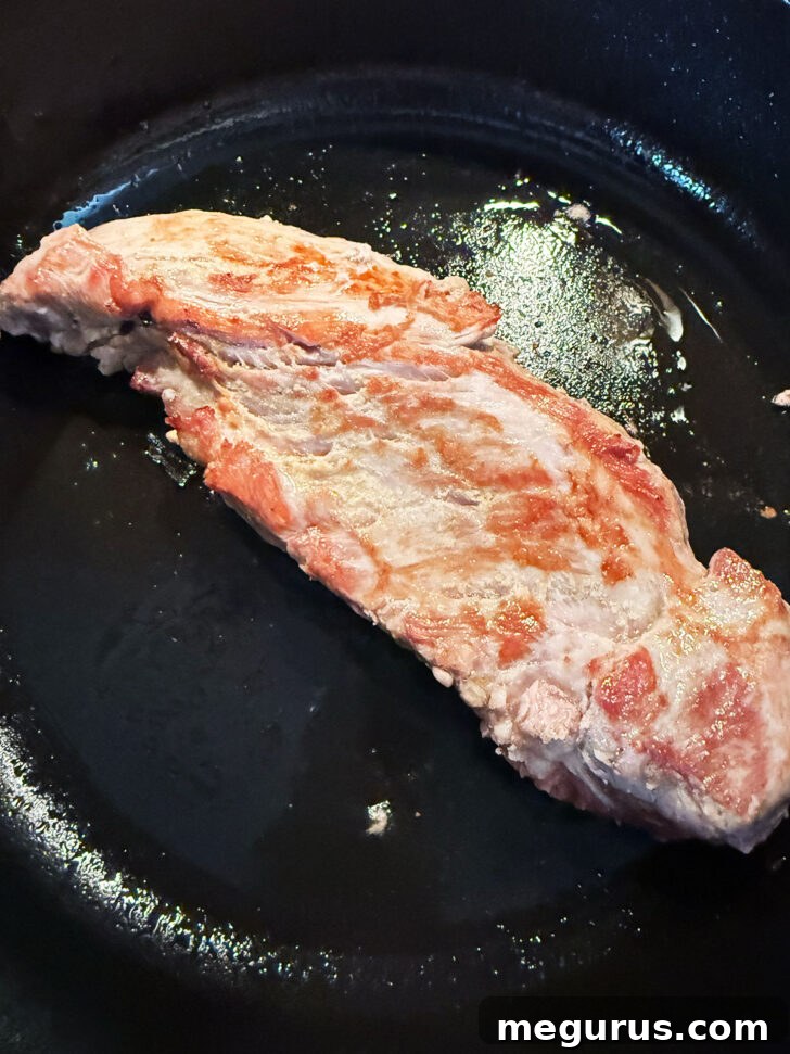 Pork tenderloin after browning in the skillet.
