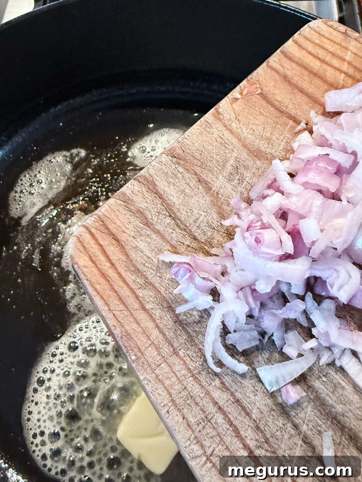 Adding the shallots to melted butter in the skillet.