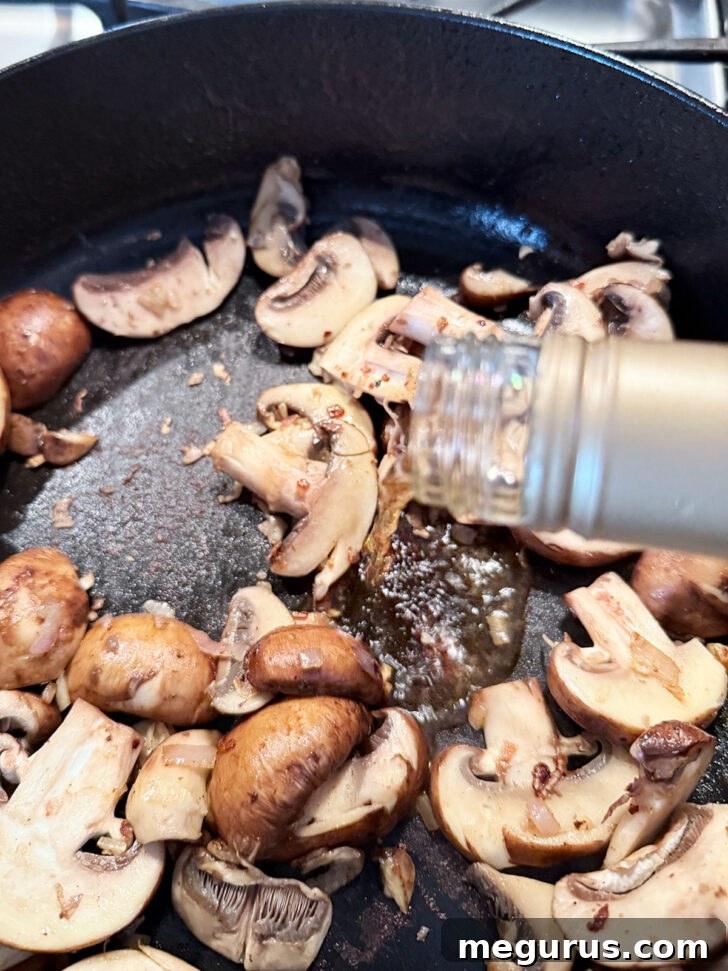 Adding the white wine to the skillet.