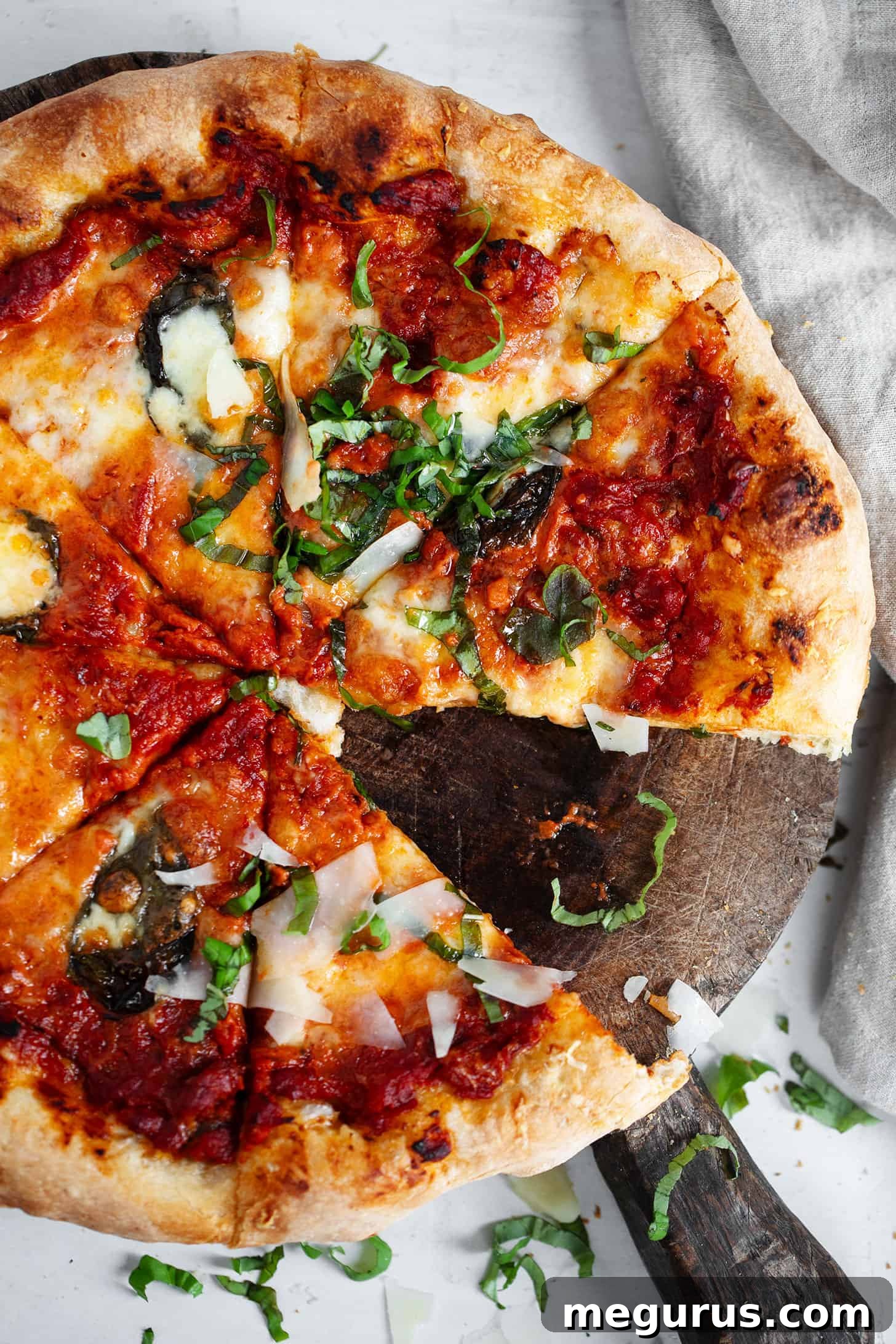 Vodka sauce pizza sliced on cutting board, showcasing its rich toppings and golden crust.