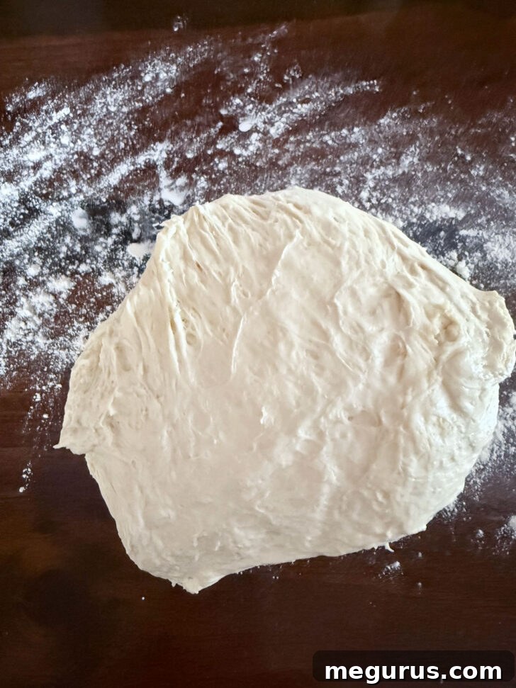 Removing the dough to a floured work surface.