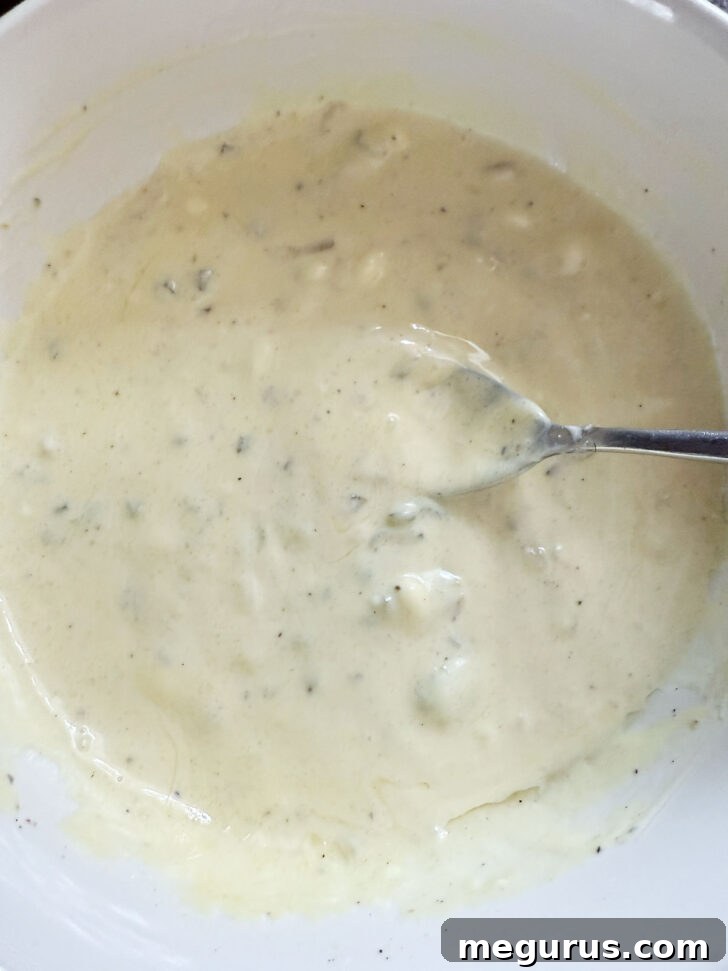 Pickle coleslaw dressing after mixing together, showing smooth texture.