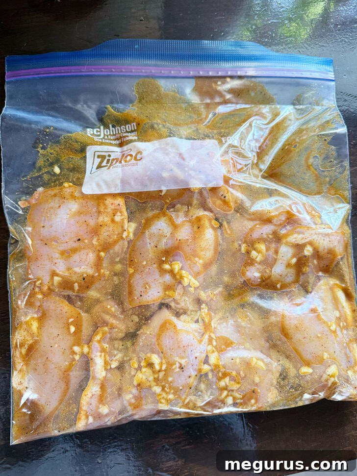Chicken with shawarma marinade resting in a zipper bag in the refrigerator.
