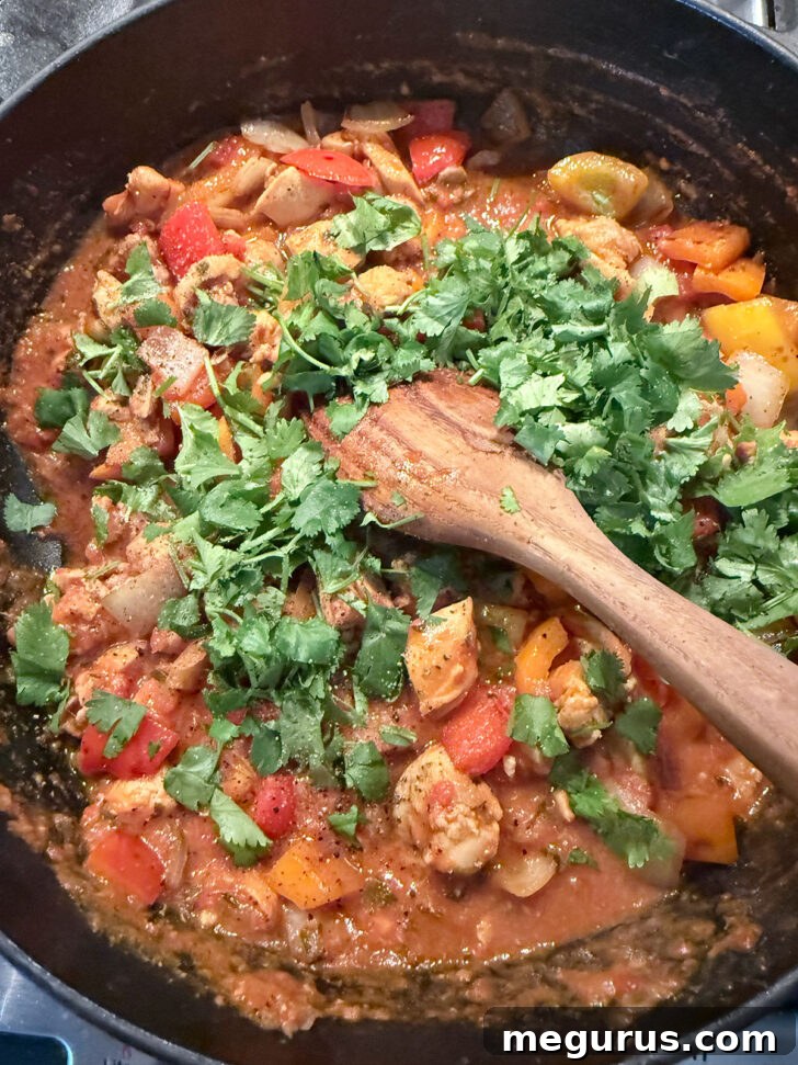 The finished Chicken Jalfrezi, generously garnished with fresh chopped cilantro, ready to be served with rice and naan.