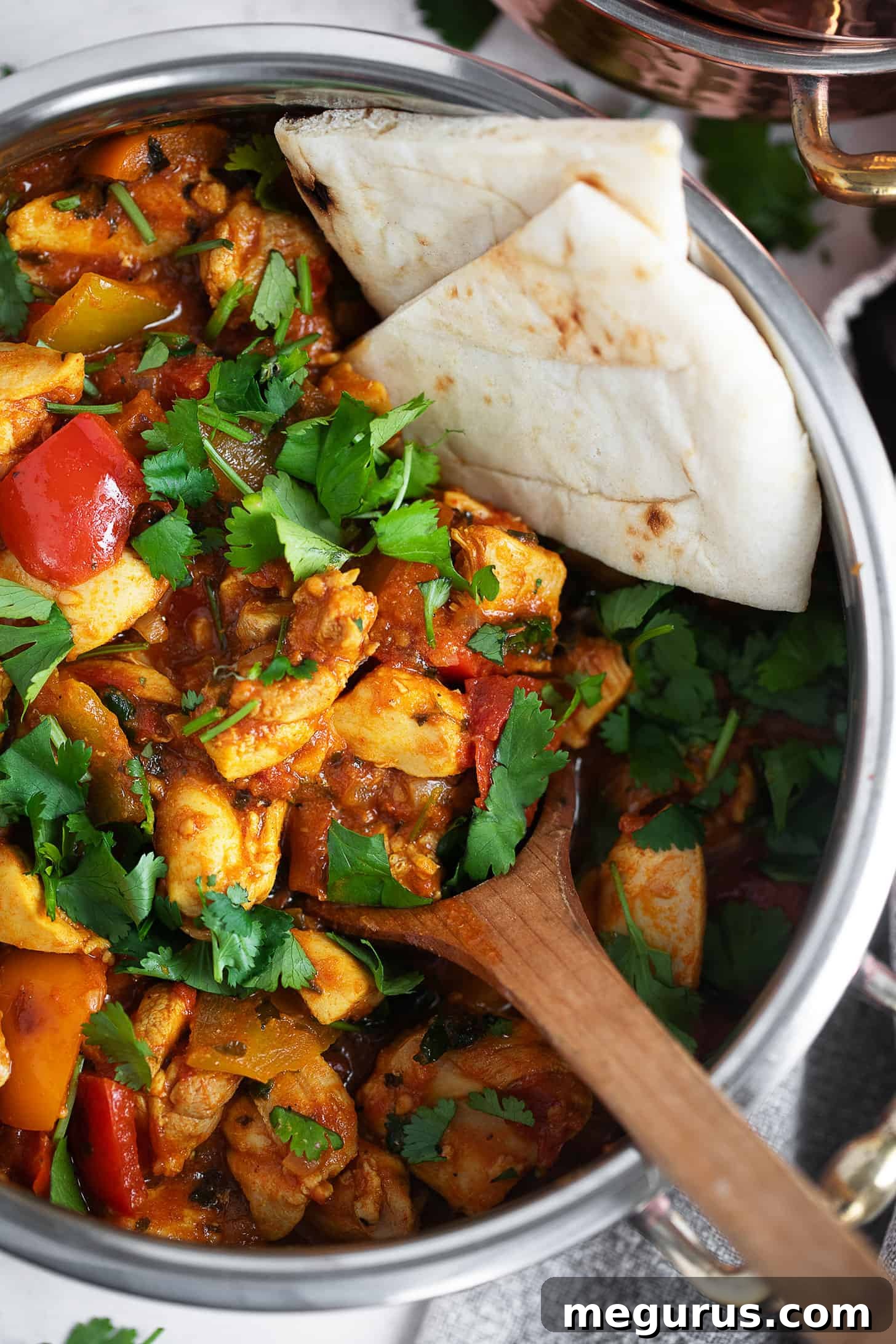 Close-up of vibrant Chicken Jalfrezi garnished with fresh cilantro, ready to be served, showcasing the rich texture and colorful vegetables.